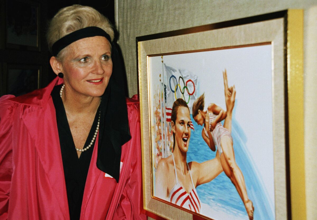 Pat McCormick stands in front of artwork depicting her Olympic feats.