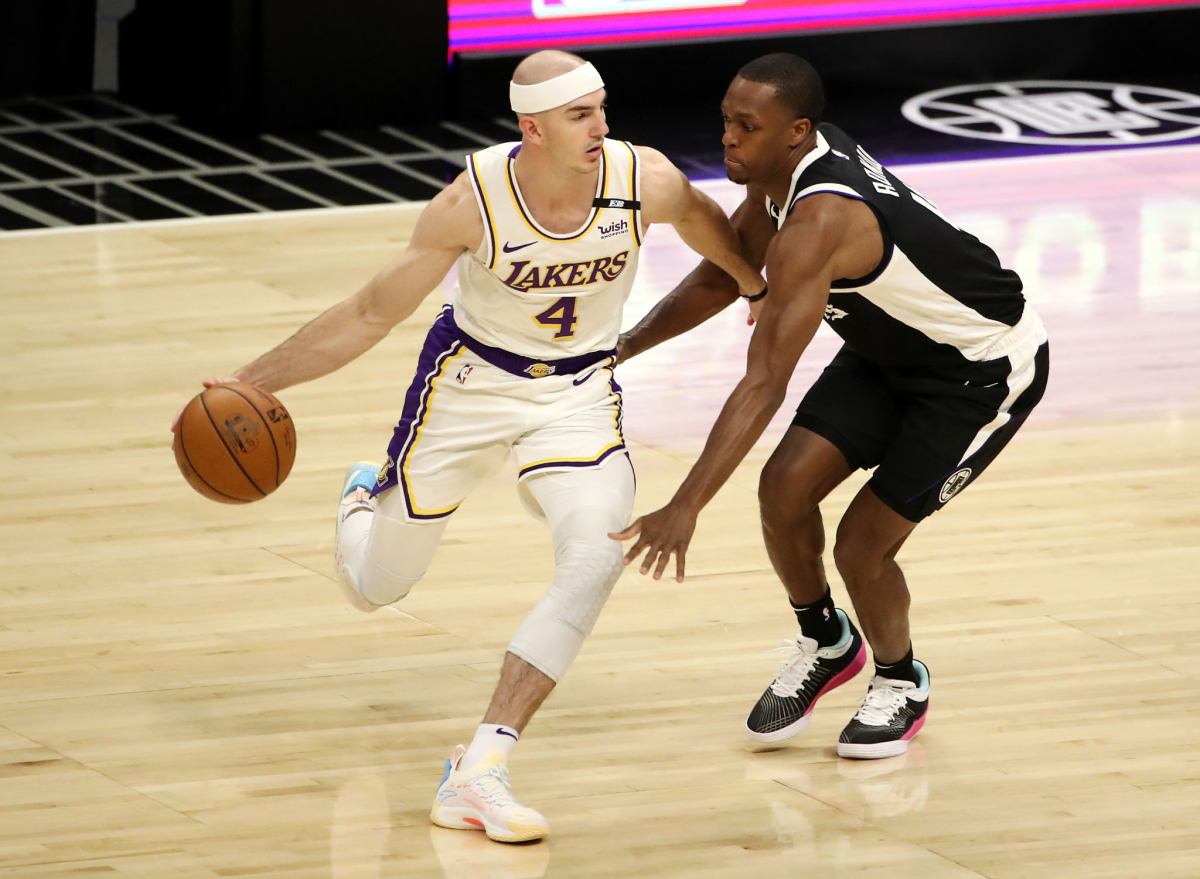 Clippers guard Rajon Rondo defends against Lakers guard Alex Caruso.
