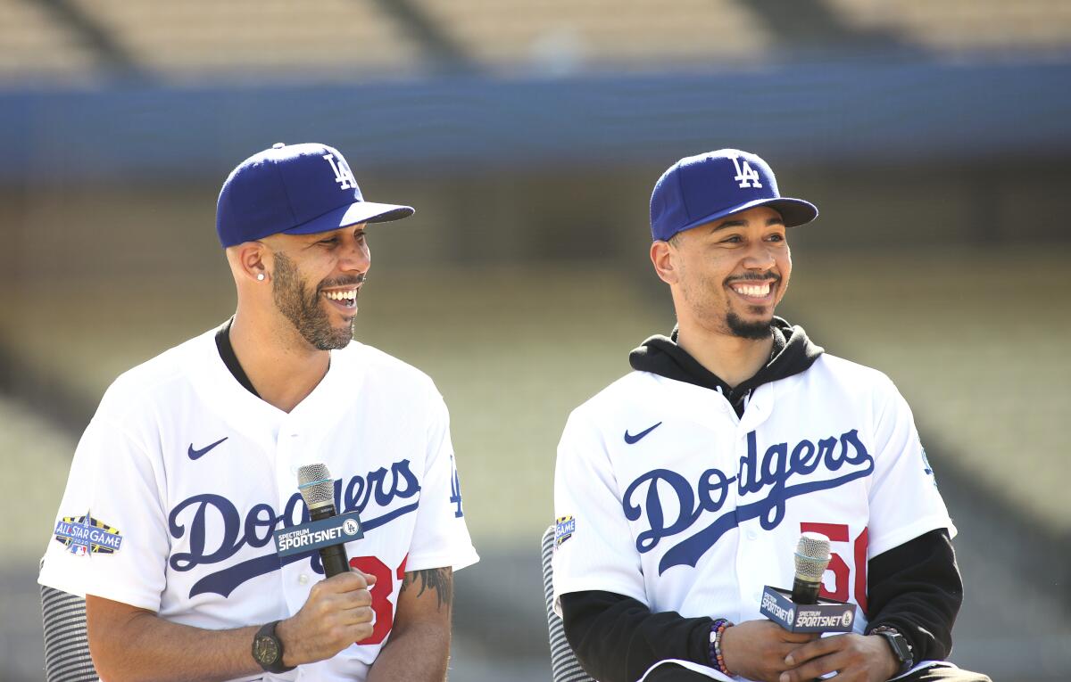 David Price and Mookie Betts, in Dodgers jerseys, hold microphones. 