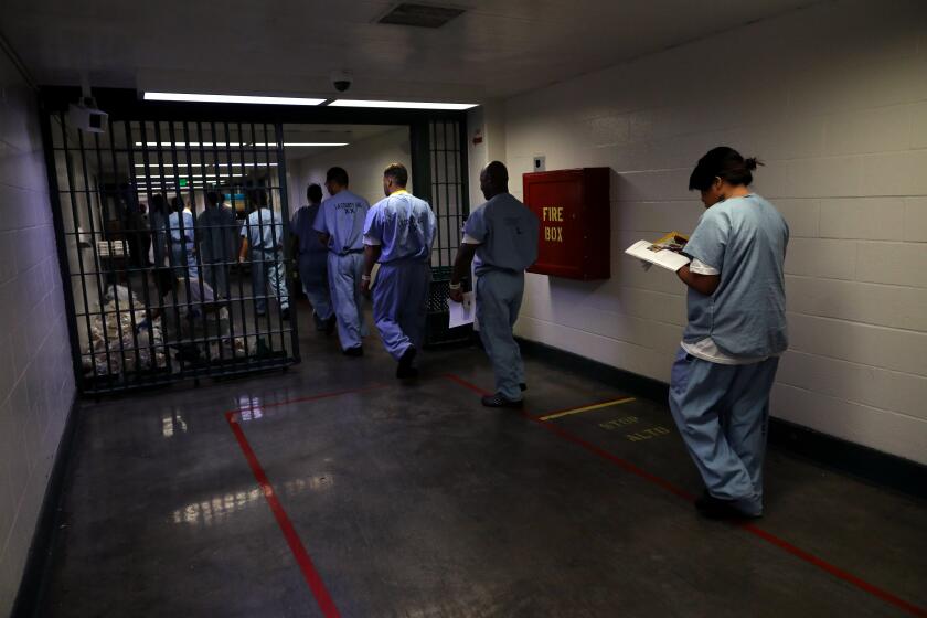 LOS ANGELES, CALIF. -- THURSDAY, AUGUST 29, 2019: Inmates return to their hiding area after attending a listening circle lead by Dennis Gibbs, Episcopal senior chaplain, at the gay and transgender unit at the Los Angeles County Sheriff's Department Men's Central Jail in Los Angeles, Calif., on Aug. 29, 2019. Religious chaplains provide stability and counseling to inmates who are at a time of crisis. Los Angeles County provides no funding for chaplains, which means that these services depend on chaplains who volunteer their time or who are paid for by outside religious organizations. (Gary Coronado / Los Angeles Times)