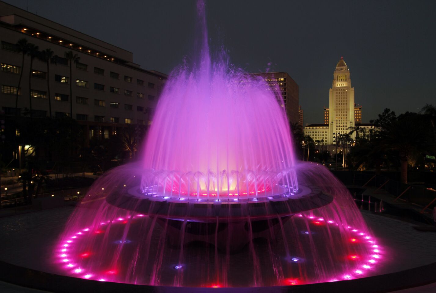 Grand Park, which opened in July, begins near the top of Bunker Hill along Grand Avenue with the renovated Arthur J. Will Memorial Fountain and a dramatic view of the tall white crest of Los Angeles City Hall. The fountain is programmed to run a colorful light show each hour. MORE: Will downtown L.A.'s Grand Park succeed? | Photos