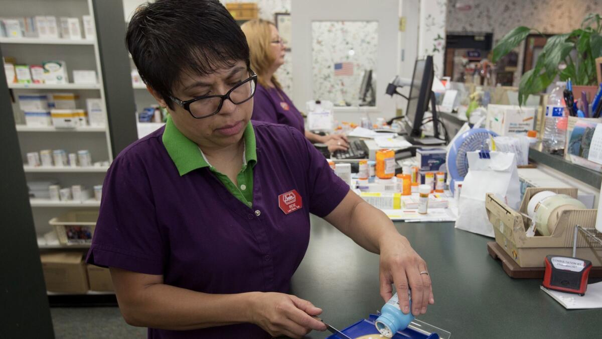 A pharmacist technician fills a prescription in Sacramento. Allergan's lawsuit against Imprimis won't do much to reduce drug prices.