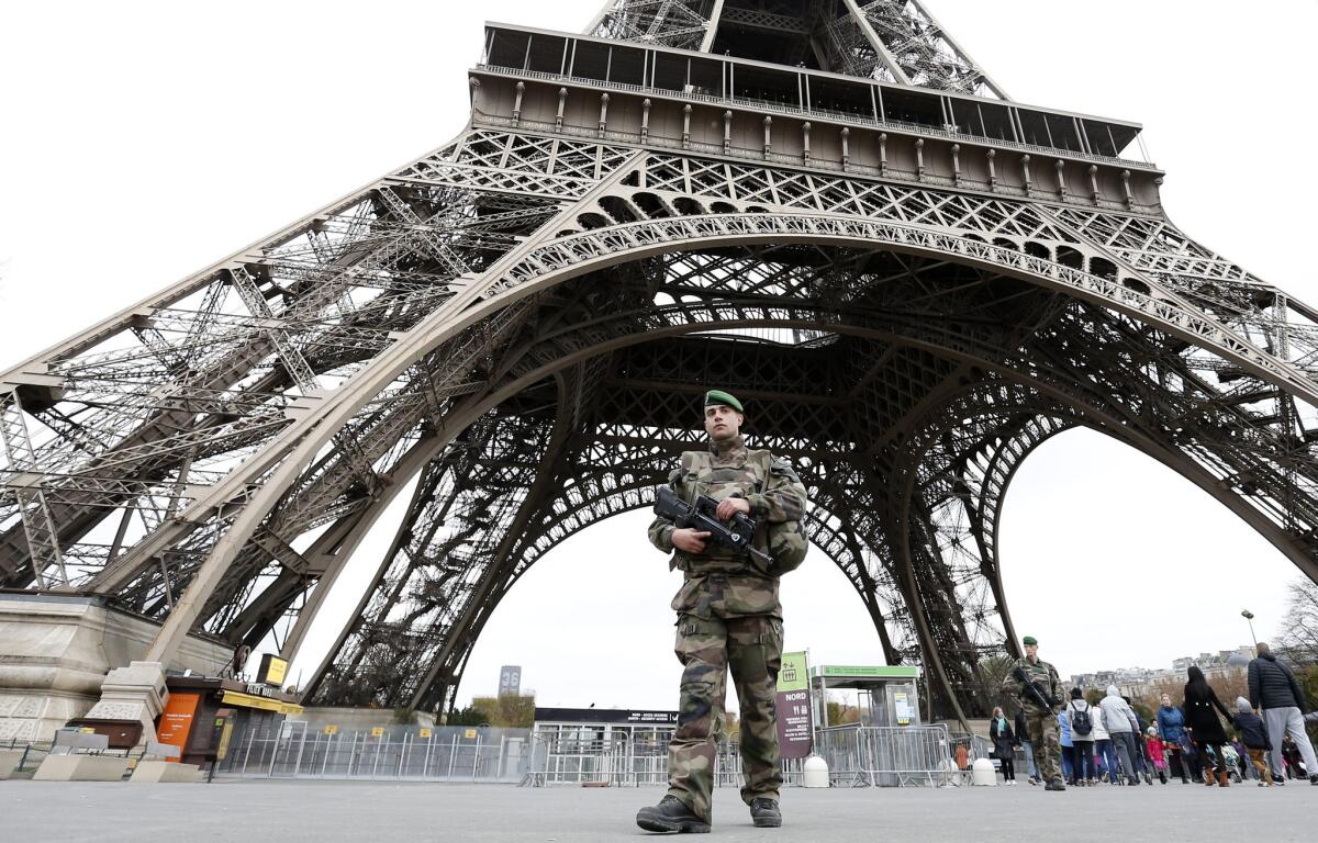 A soldier patrols under the Eiffel Tower in Paris on Nov. 14.