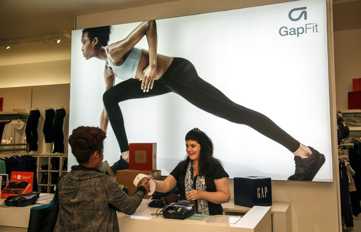 Judy Slater helps a customer at the Westfield Fashion Square Gap store in Sherman Oaks in November.