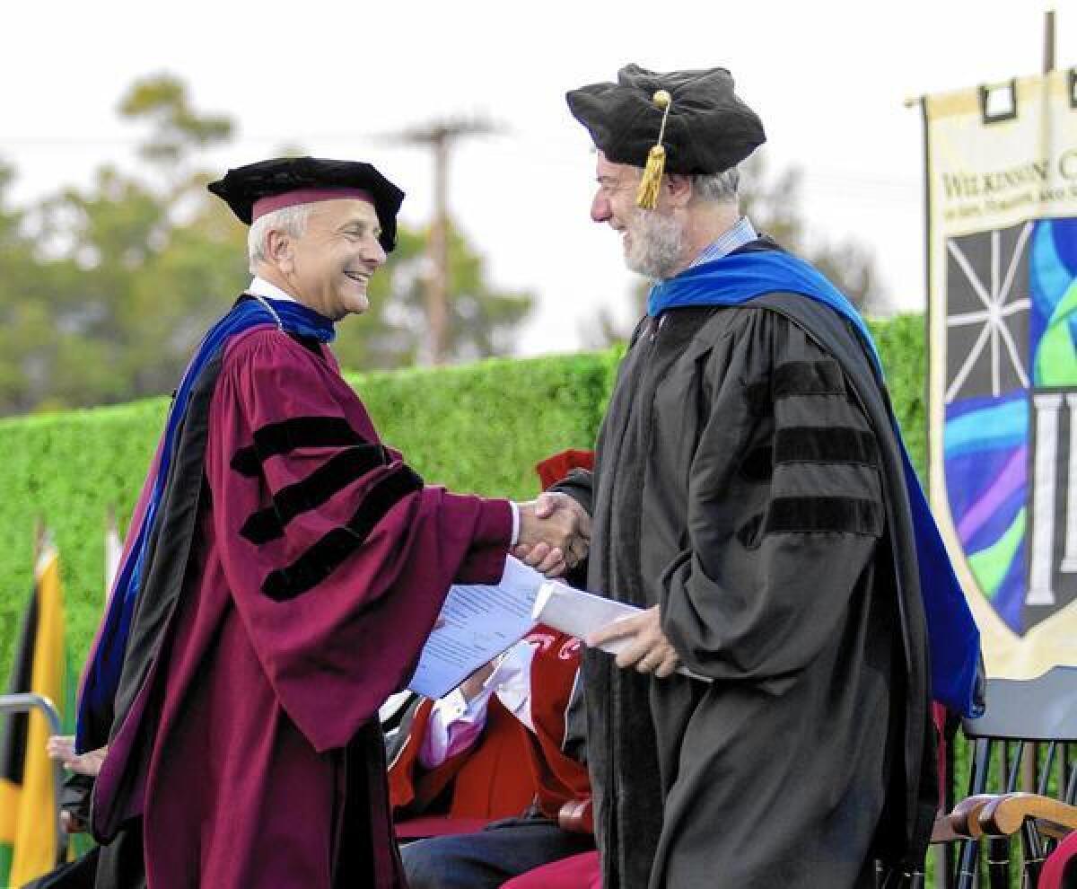 Outgoing Chapman President Jim Doti and incoming President Daniele Struppa greet each other onstage at Chapman University’s Opening Convocation.