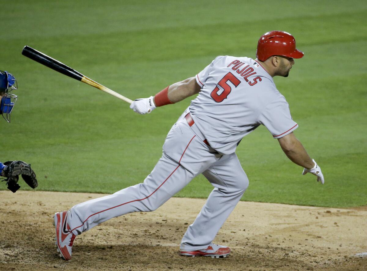 The Angels' Albert Pujols watches his two-RBI single against the Dodgers in Los Angeles on May 16.