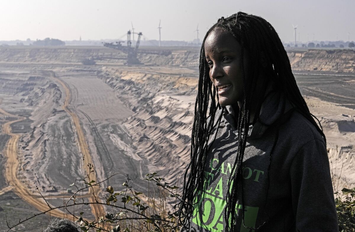 Climate activist Vanessa Nakate from Uganda gives an interview to the Associated Press during her visit to the Garzweiler open-cast coal mine in Luetzerath, western Germany, Saturday, Oct. 9, 2021. Garzweiler, operated by utility giant RWE, has become a focus of protests by people who want Germany to stop extracting and burning coal as soon as possible. (AP Photo/Martin Meissner)