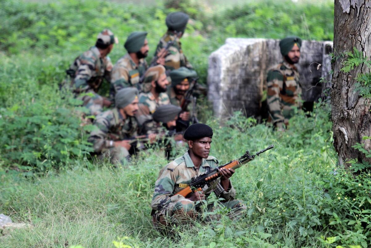 Soldiers take cover during a militant attack on a camp in India's Jammu and Kashmir state.