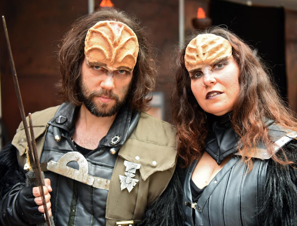 Two fans dressed up as Klingons at the sci-fi fan meeting FedCon in Bonn on May 13, 2016.
