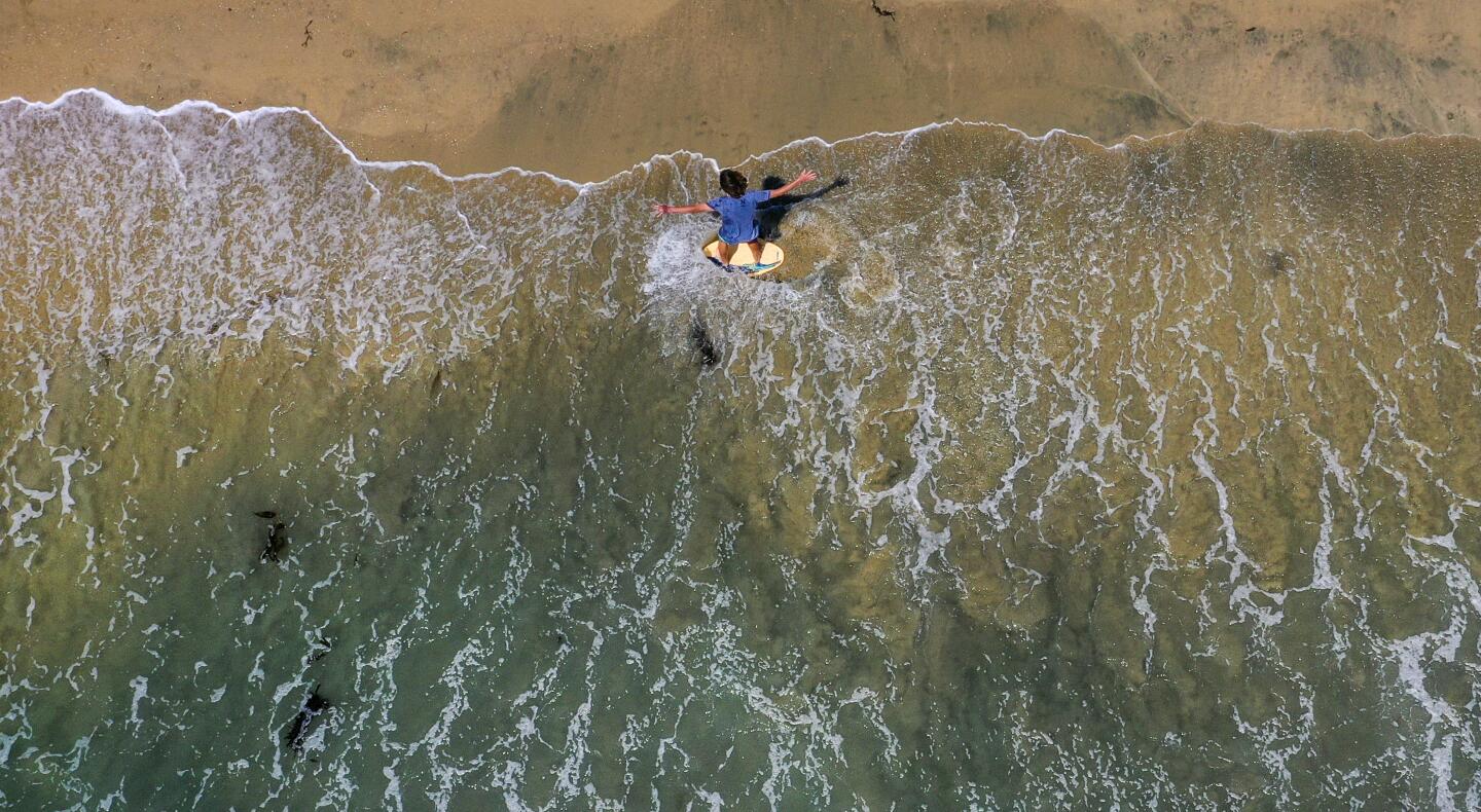 Drone view of a skim boarder in Seal Beach