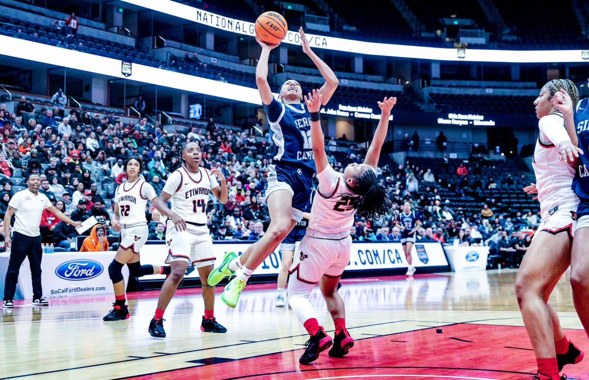 Juju Watkins of Sierra Canyon scores over Etiwanda's Aliyahna Morris in the Open Division girls' final at Honda Center.