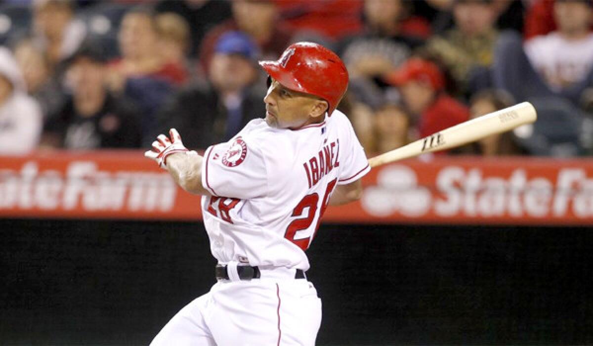 Raul Ibanez hits a two-run home run in the fourth inning of the Angels' loss Tuesday to Seattle, 8-3, at Angel Stadium.