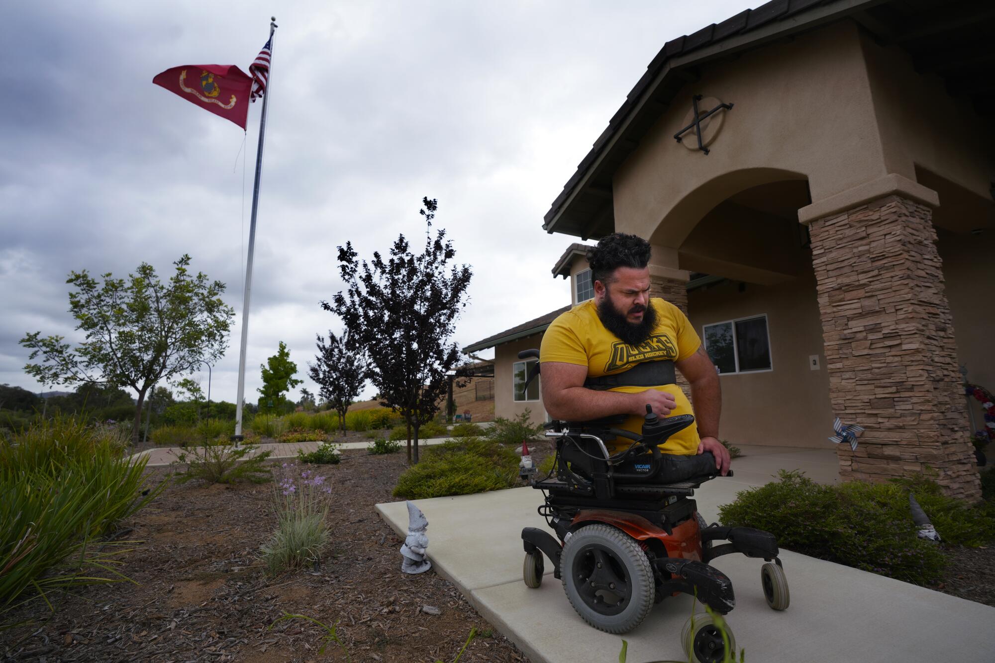  Jason Ross, who lost his legs while serving in Afghanistan, maneuvers in an automated wheelchair