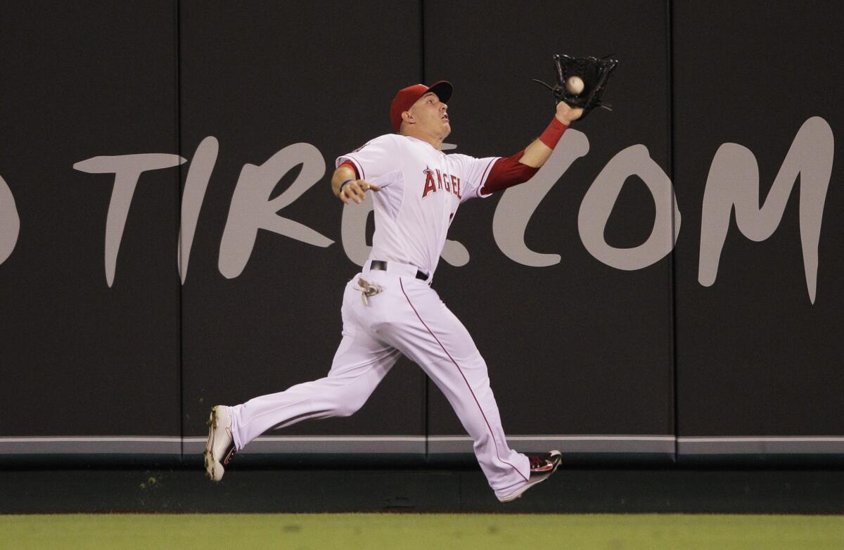 Angels center fielder Mike Trout makes a long run for a catch on the warning track on a ball hit by second baseman Jose Altuve in the sixth inning.