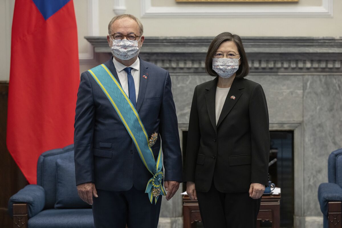 In this photo released by the Taiwan Presidential Office, Taiwanese President President Tsai Ing-wen, right pose with French Senator Joel Guerriau, vice chairman of the Senate Committee on Foreign Affairs, Defense and the Armed Forces during a visit at the Presidential Office in Taipei, Taiwan on Thursday, June 9, 2022. A French parliamentary delegation pledged support for Taiwan during a meeting Thursday with the president of the self-governing island that China claims as its own territory with no right to diplomatic recognition. (Taiwan Presidential Office via AP)