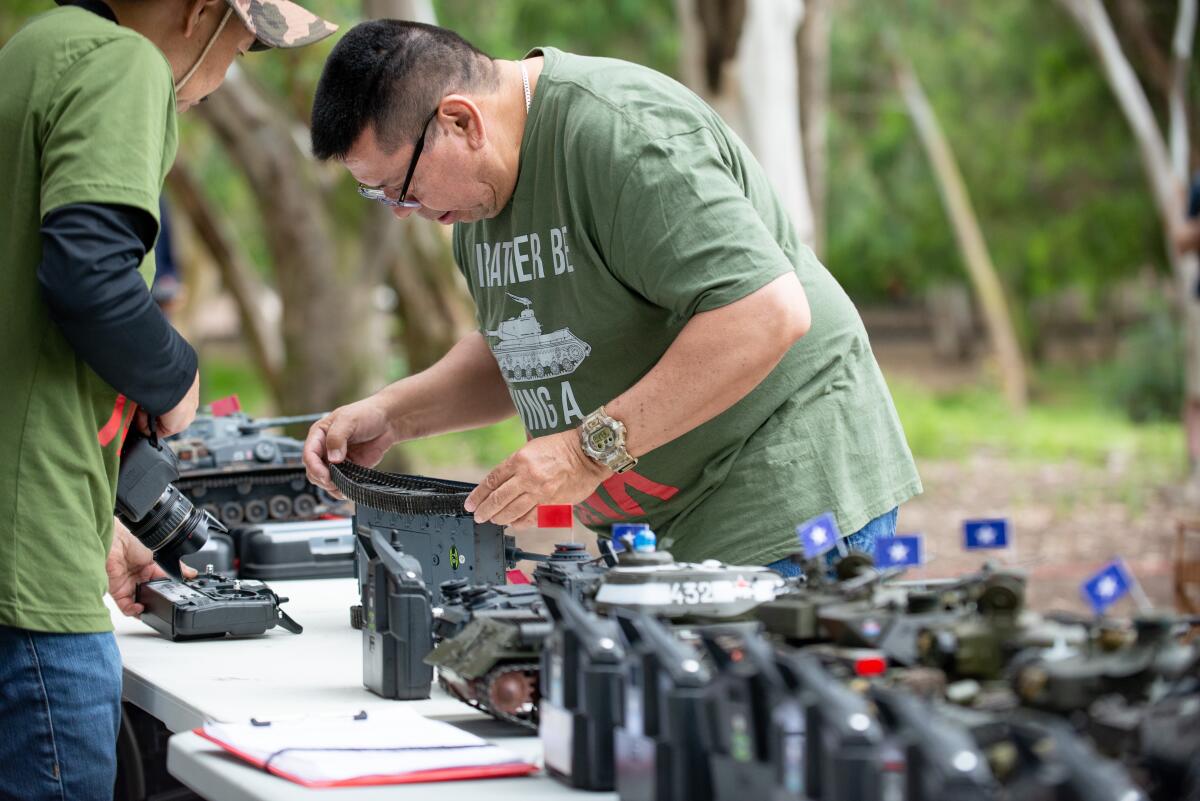 Members of the Irvine RC Tank Club make repairs to models.