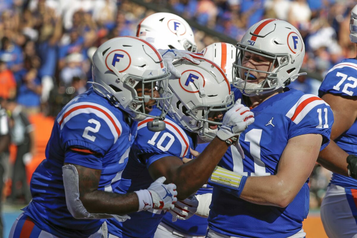 Florida wide receiver Josh Hammond (10) celebrates with running back Lamical Perine (2) after catching a touchdown pass against Auburn during the first half of an NCAA college football game, Saturday, Oct. 5, 2019, in Gainesville, Fla. (AP Photo/John Raoux)