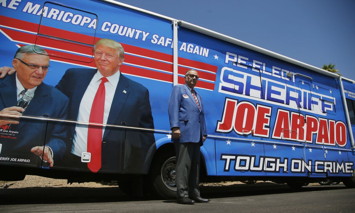 Former Maricopa County Sheriff Joe Arpaio, poses for a photograph in front of his campaign vehicle as he is running for the position of Maricopa County Sheriff again, Wednesday, July 22, 2020, in Fountain Hills, Ariz. Arpaio is trying to win back the sheriff’s post in metro Phoenix that he held for 24 years. He faces his former second-in-command, Jerry Sheridan, in the Aug. 4 Republican primary in what has become his second comeback bid. (AP Photo/Ross D. Franklin)