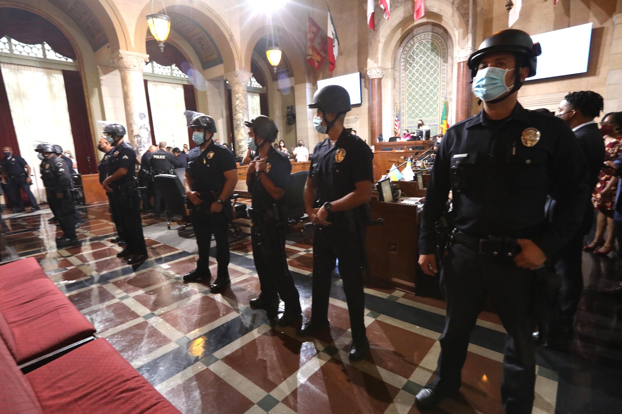 LAPD officers stand guard after a homeless advocate tried to rush City Council members at City Hall.