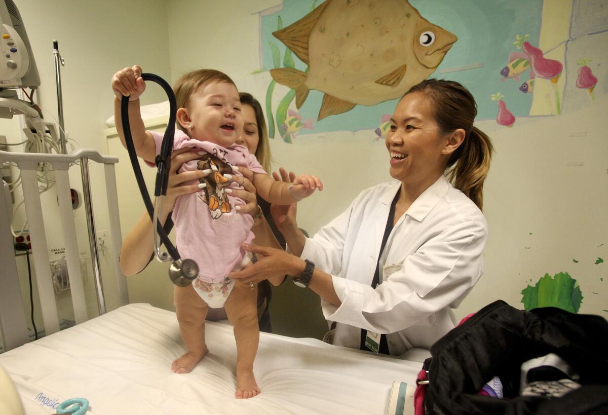 Serena Remington, 10 months, gets treatment at a Long Beach Hospital: Obamacare is only a bit older than she is, and already making its mark.