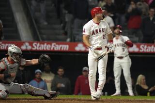 Los Angeles Angels' Mike Trout, center, reacts after striking out to end the baseball game.