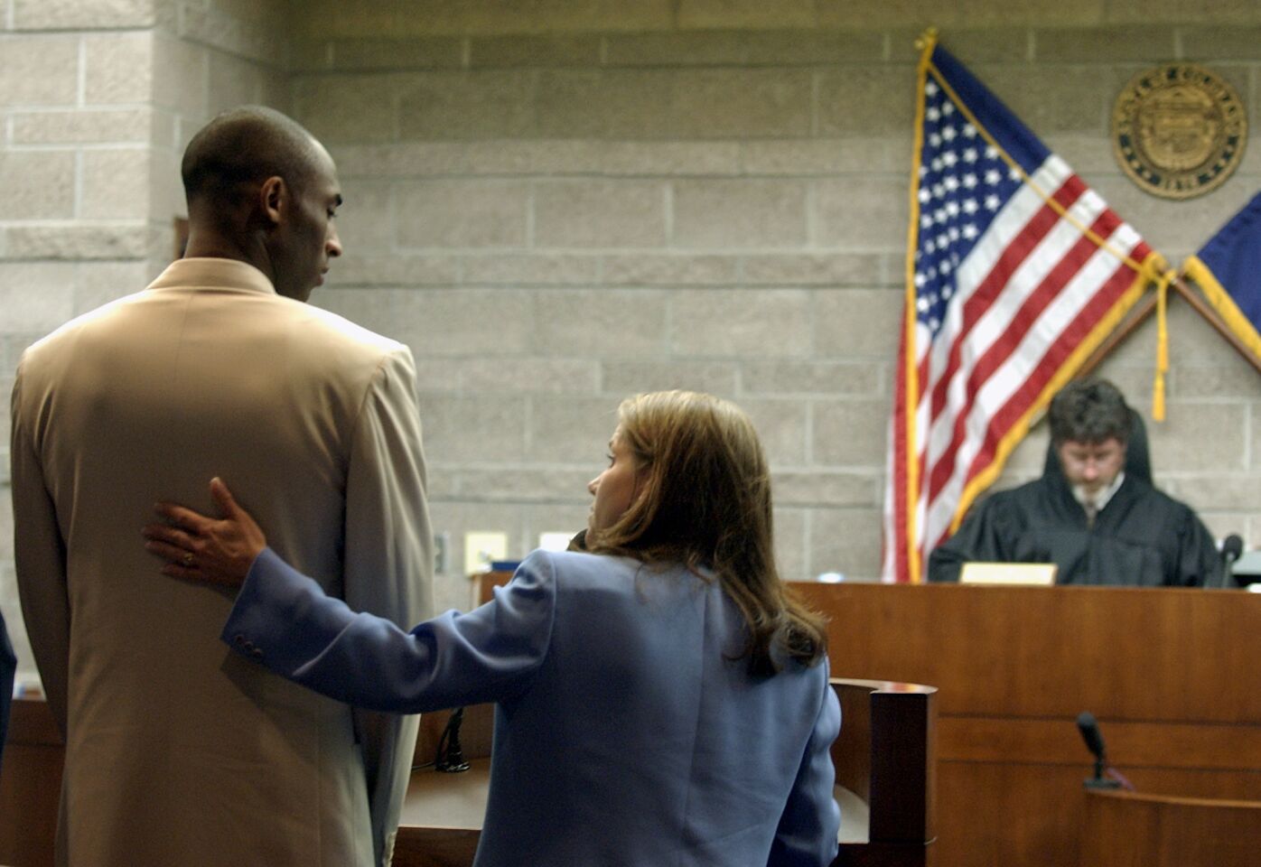 Kobe Bryant, with defense attorney Pamela Mackey, stands before Eagle County Judge Frederick Gannett on Aug. 6, 2003.
