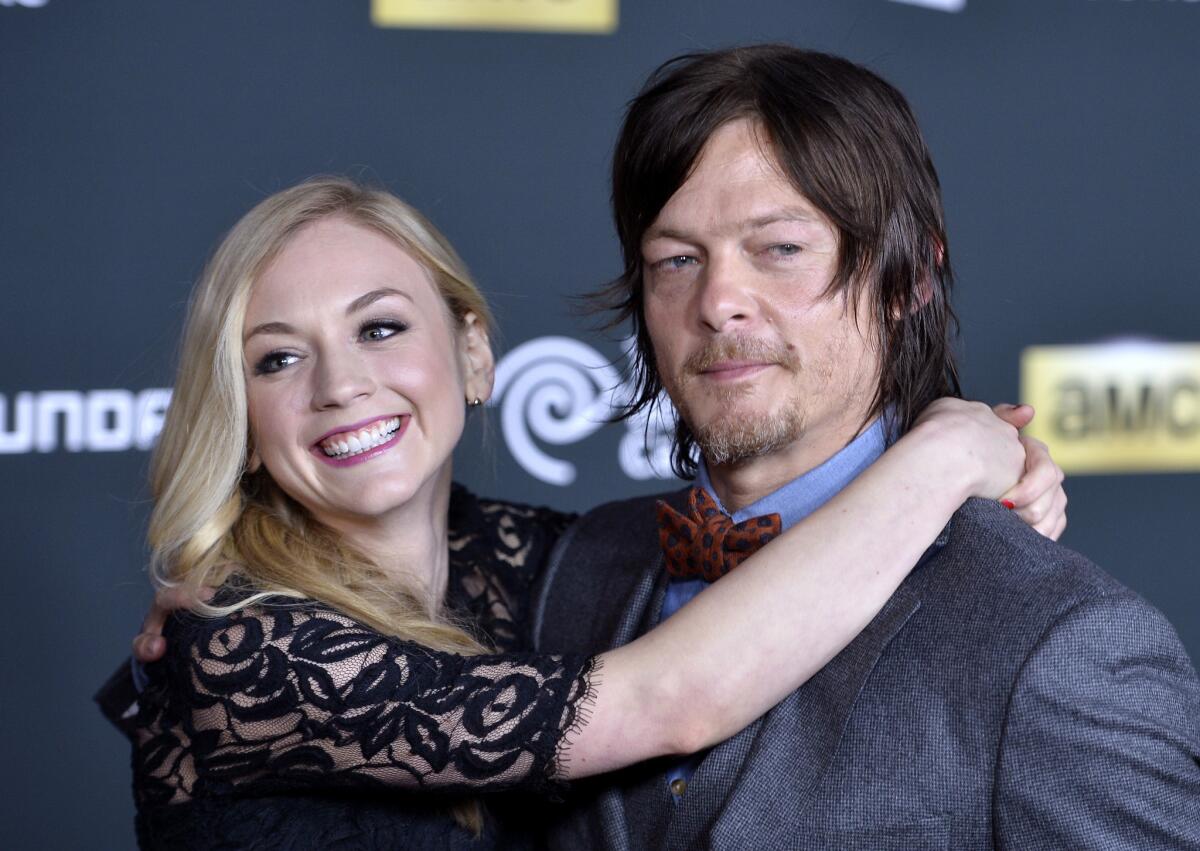 "The Walking Dead's" Emily Kinney and Norman Reedus, shown in 2013, are not dating, his rep said.