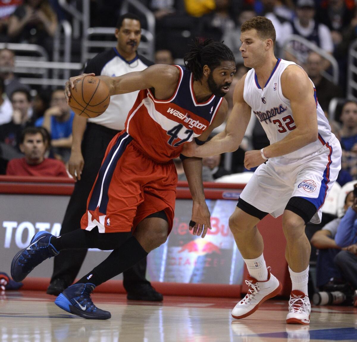 Washington Wizards forward Nene Hilario, left, drives against Clippers forward Blake Griffin during a game last season.