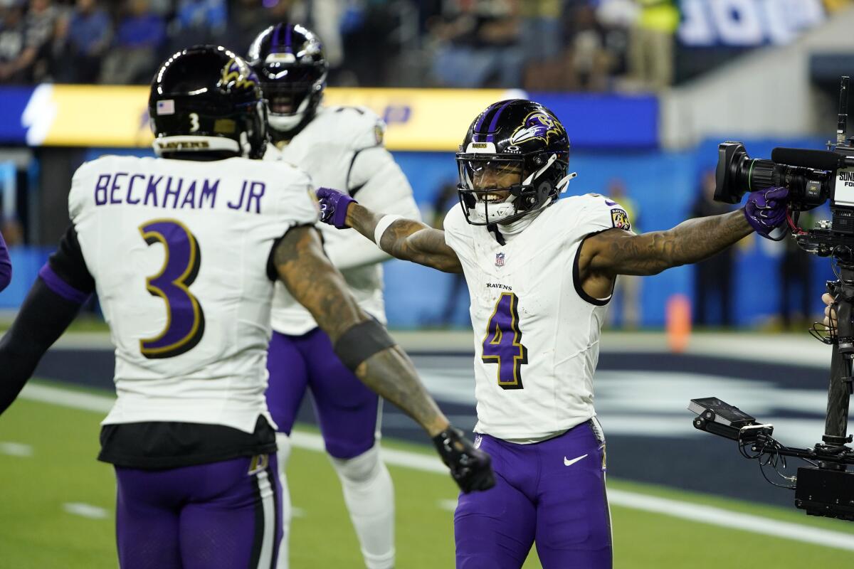 The Ravens' Zay Flowers, right, celebrates a touchdown against the Chargers.