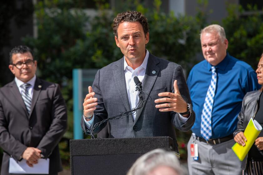 Oceanside, CA - April 18: San Diego County Supervisor Nathan Fletcher, center, addresses the crowd during the dedication ceremony for the new North Coastal Live Well Center Community-Based Crisis Stabilization Unit (CSU) Monday, April 18, 2022 in Oceanside, CA. The facility is set to open on Monday, April 25, the CSU will provide community based 24/7 walk-in mental health and substance use services for those in a behavioral health crisis, with stays of less than 24 hours. (Don Boomer / For The San Diego Union-Tribune)