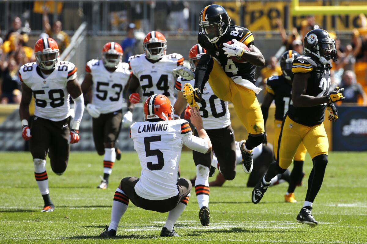 Pittsburgh punt returner Antonio Brown kicks Cleveland punter Spencer Lanning during Sunday's game.