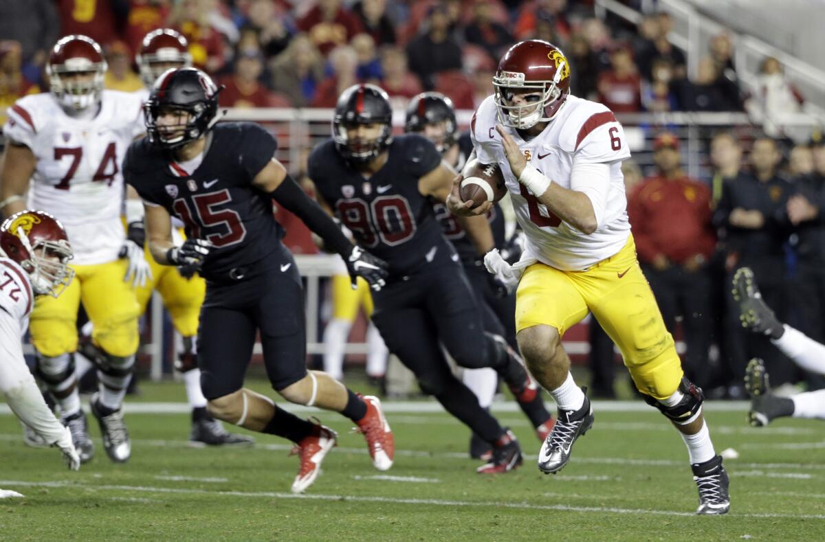 USC quarterback Cody Kessler runs from Stanford defenders during the Pac-12 championship game on Dec. 5. The Dec. 30 Holiday Bowl will be his final game as a Trojan.