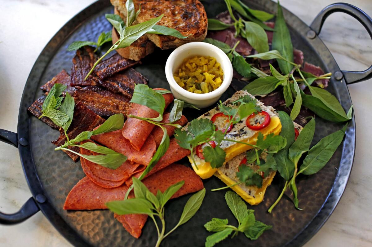 Cassia's charcuterie platter includes Singaporean Candied Pork, Lamb Ham, Vietnamese Meatloaf and Smoked Red Sausage.