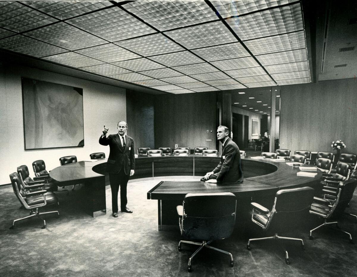 Times Mirror CEO Dr. Franklin Murphy, left, shown with director Peter S. Bing in 1973, helped build the collection, including a Helen Frankenthaler piece in the boardroom.