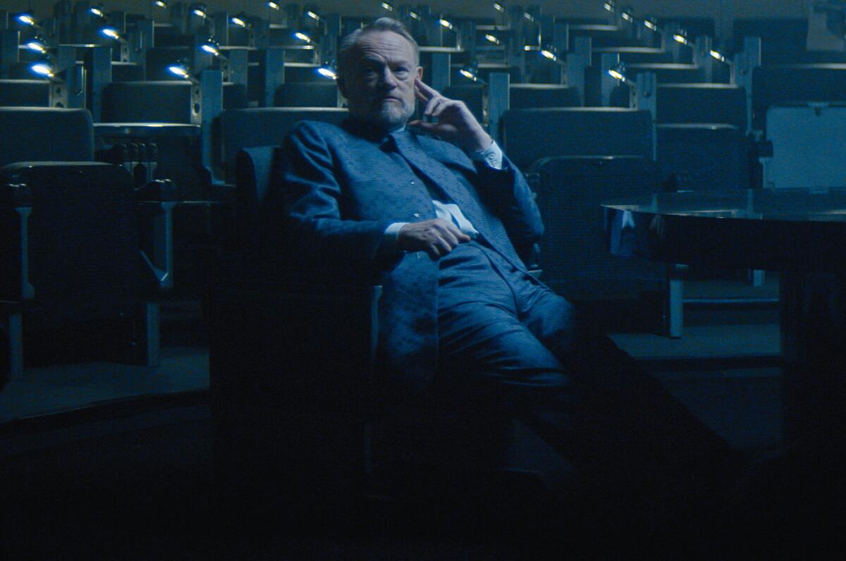 Jared Harris leans back in a chair in a scene from "Foundation."