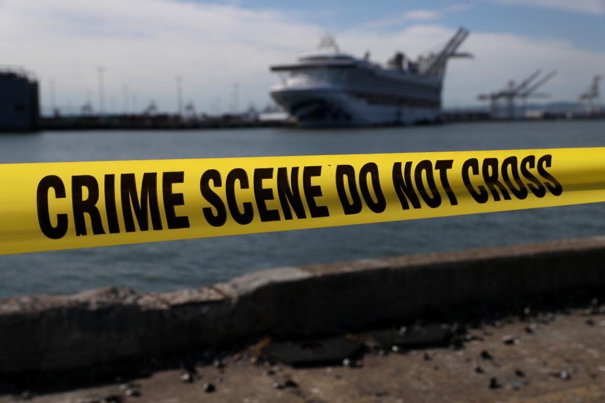 Crime scene tape marks off the area where members of the media are staging near the Princess Cruises Grand Princess cruise ship as it sits docked in the Port of Oakland.
