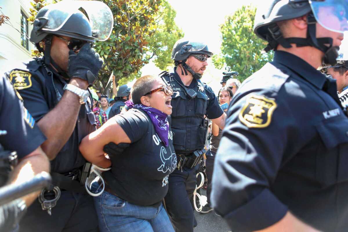 Riot police arrest a counter-protester during the "No To Marxism" rally at Berkeley's Martin Luther King Jr. Civic Center Park.