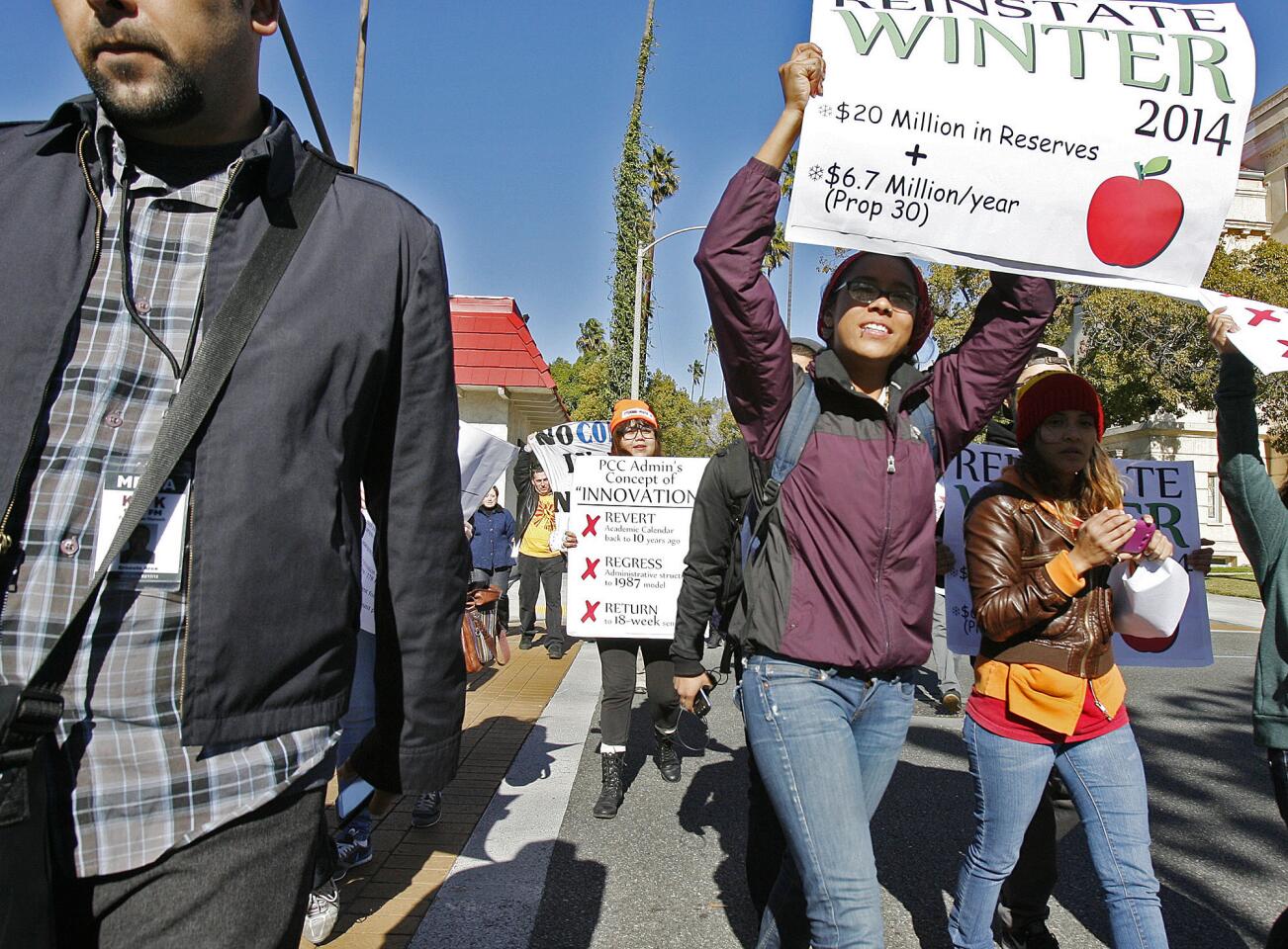 PCC students, carrying picket signs walk across Colorado Blvd. with several Pasadena City College students and faculty in a protest at Pasadena City College on Thursday, January 10, 2013. Students and faculty are upset about the handling of the school's budgets and the cuts that are effecting them.