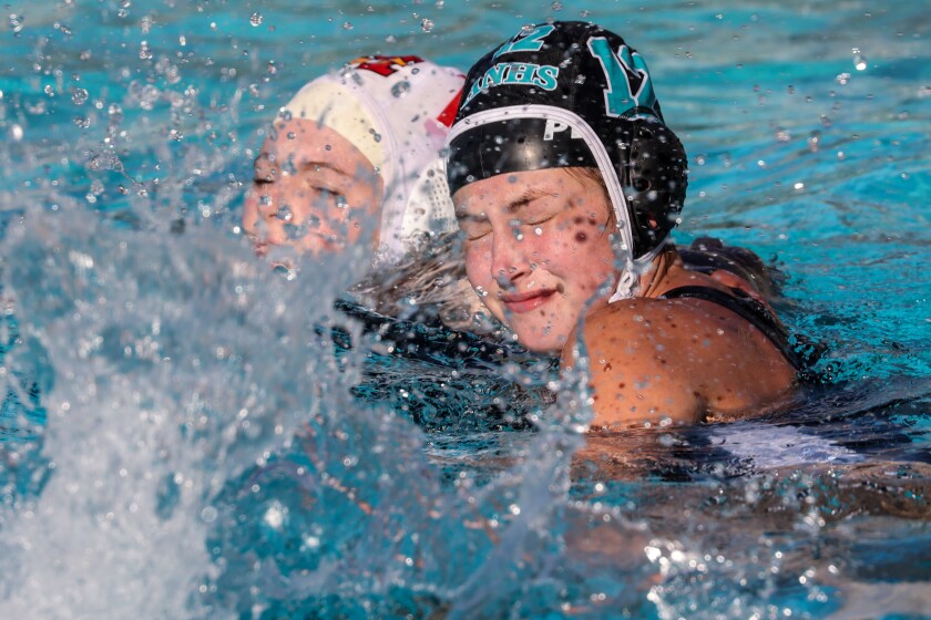 Casey Pearlman vies with a Mission Viejo player for position during a water polo match. 