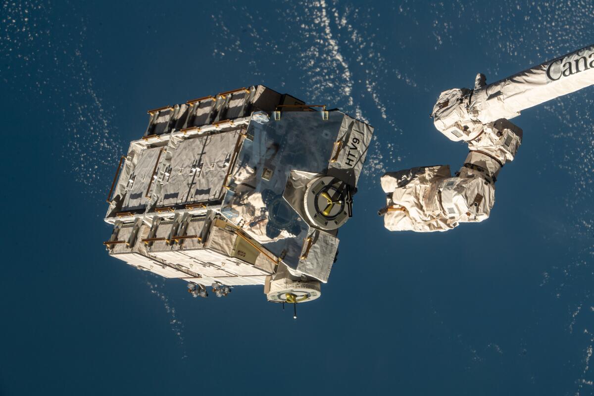 An external pallet packed with old nickel-hydrogen batteries is released from the Canadarm2 robotic arm