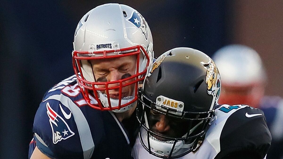 Collisions like this between the Patriots’ Rob Gronkowski (left) and the Jaguars’ Barry Church likely would come under scrutiny with the new helmet rule.