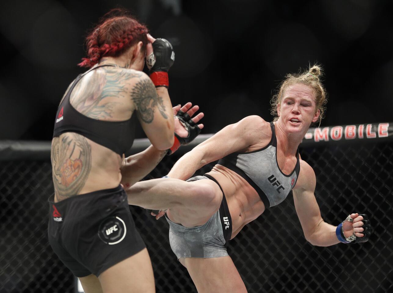 Holly Holm kicks Cris Cyborg during a featherweight championship mixed martial arts bout at UFC 219.
