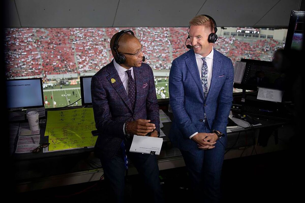 In a photo provided by Fox Sports, Gus Johnson, left, and Joel Klatt prepare for the Sept. 4, 2021, NCAA college football game between Penn State and Wisconsin in Madison, Wis. Johnson and Klatt will be on the call for Saturday's game when No. 4 Penn State visits third-ranked Iowa. The two began working together in 2015 when Klatt became Fox's top college football analyst after Charles Davis shifted over to NFL. (Fox Sports via AP)
