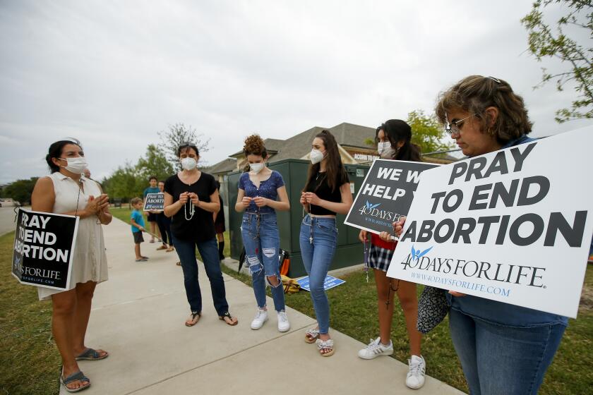Anti-abortion demonstrators pray and protest outside of a Whole Women's Health of North Texas, Friday, Oct. 1, 2021, in McKinney, Texas. A federal judge did not say when he would rule following a nearly three-hour hearing in Austin during which abortion providers sought to block the nation's most restrictive abortion law, which has banned most abortions in Texas since early September. (AP Photo/Brandon Wade)