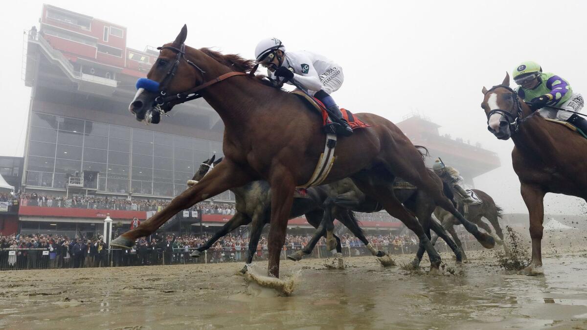 Justify, with Mike Smith aboard, wins the 143rd Preakness Stakes at Pimlico race course in Baltimore on May 19, 2018.