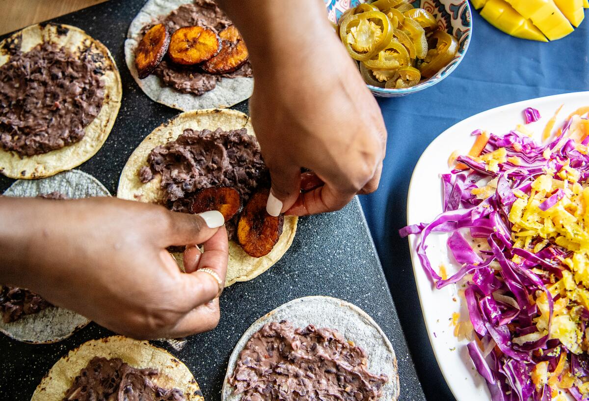 Chef Danielle Elizabeth Stevens constructs one of her dishes at her home in Ladera Heights.