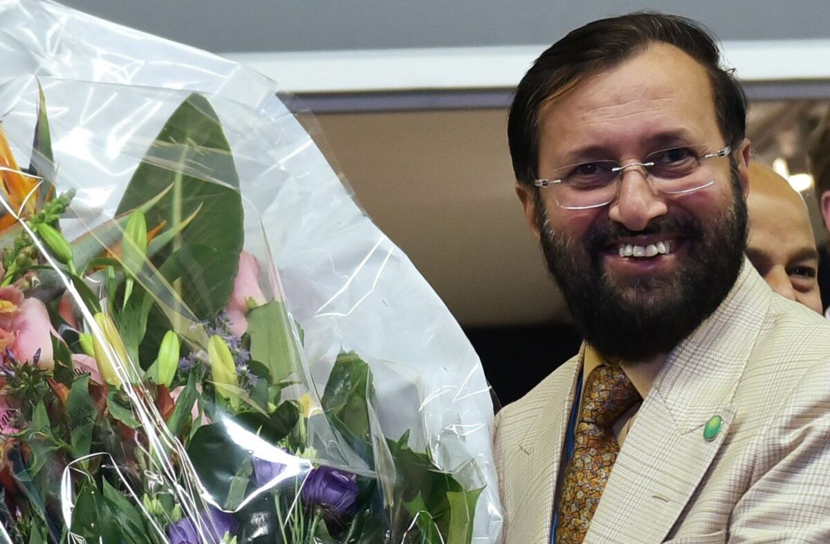 India's Environment Minister Prakash Javadekar presents a bouquet to U.S. Secretary of State John Kerry for Kerry's birthday.