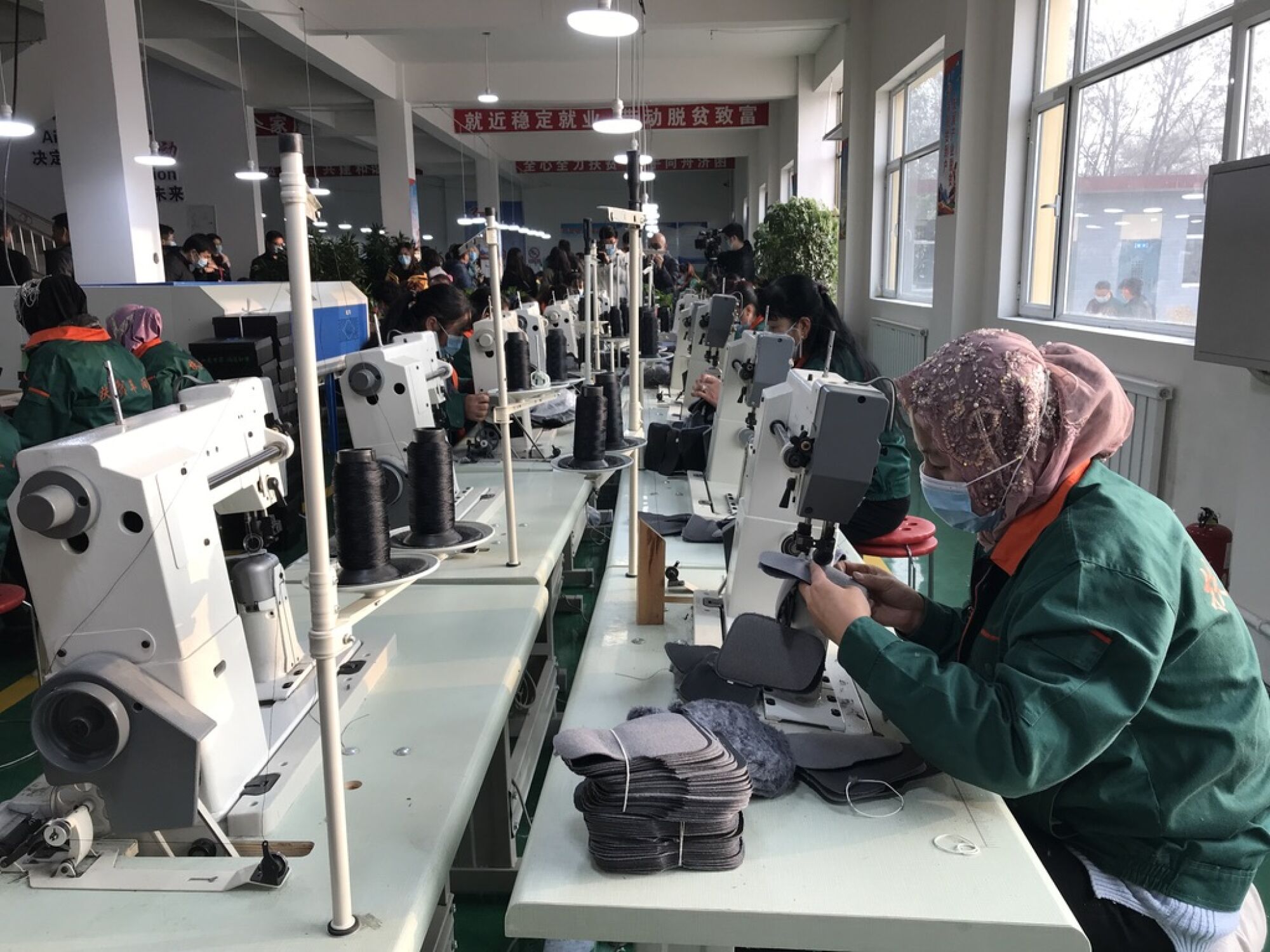 Hui minority women sew shoe interiors together at a "poverty alleviation factory" on the outskirts of Linxia.