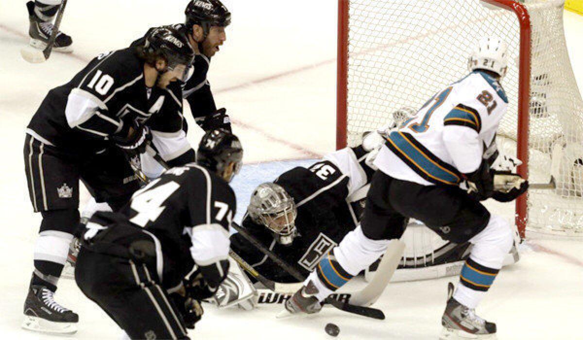 Jonathan Quick turns away a shot from TJ Galiardi during the first period of the Kings' second-round playoff matchup with the San Jose Sharks on Tuesday.