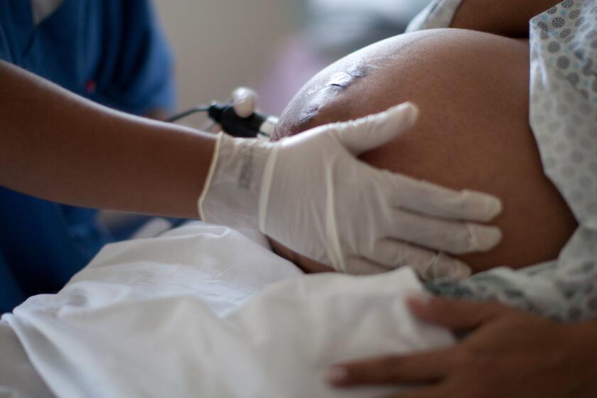 FILE - In this July 25, 2012 file photo, a pregnant woman is examined as she waits to give birth at a public hospital in Rio de Janeiro. Authorities want to turn the tide on what Health Ministry officials have called an epidemic of cesareans births in the country, with Brazil now the worlds No. 2 recipient of C-sections, second only to China in raw numbers. (AP Photo/Felipe Dana, File)
